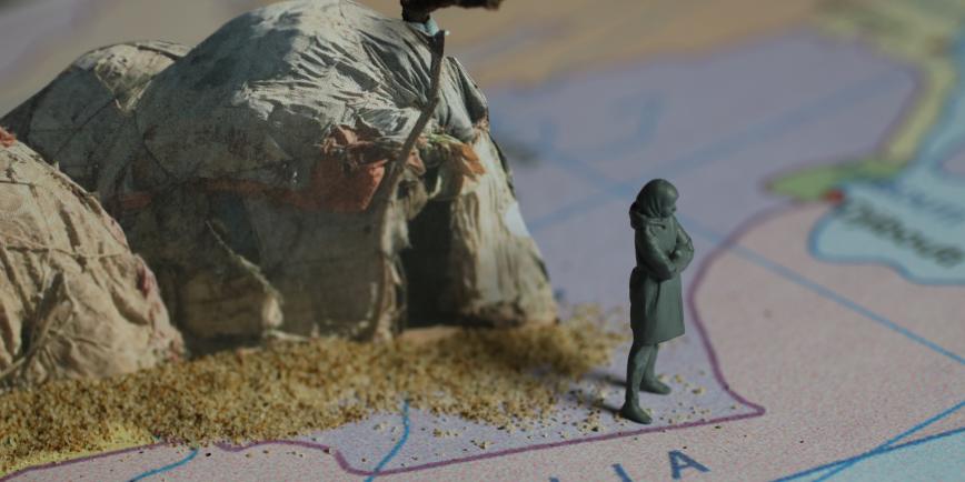 photo with a model of a woman, standing on a map and a canvas tent behind her, like an animation